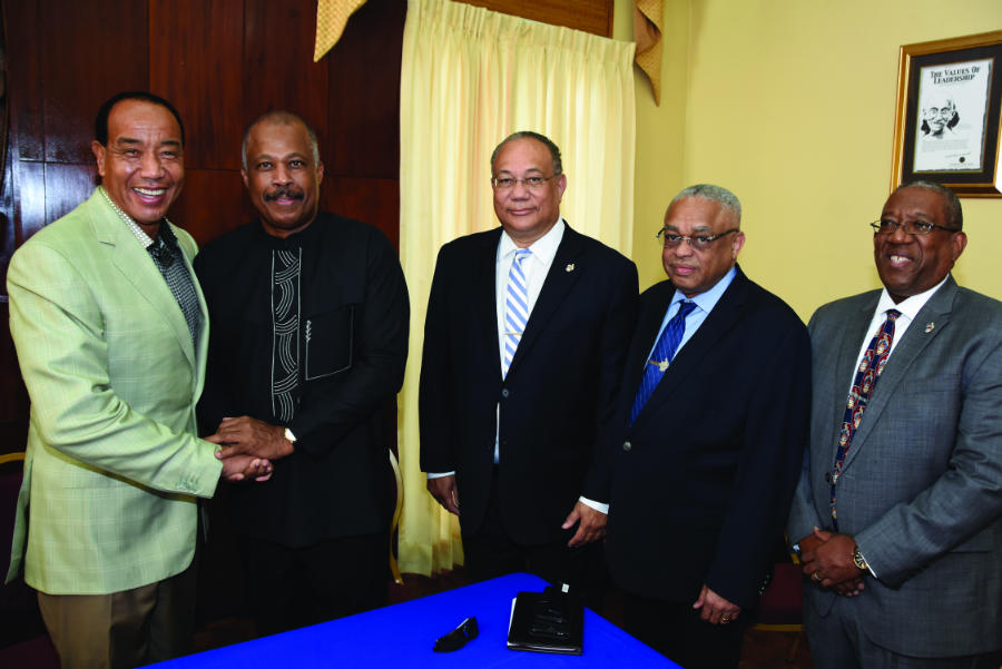 (L-R) Hon. Michael Lee-Chin, O.J., Chairman of the Economic Growth Council (EGC)
greets Sir Hilary Beckles, Vice-Chancellor, The University of the West Indies (UWI) and his colleagues Ambassador Richard Bernal, Pro Vice-Chancellor Global Affairs; Prof. Archibald McDonald, Principal, The UWI Mona and Prof. Dale Webber, Pro Vice-Chancellor Graduate Studies. Sir Hilary led The UWI team at a stakeholders meeting with the Economic Growth Council at Jamaica House on December 12, 2016. Outlining various innovations, new programmes and partnerships with international universities, Sir Hilary assured the EGC that “The UWI is fully on board with 5 in 4” the target set by the EGC of 5% growth in Gross Domestic Product in four years (2020). The EGC is a body appointed by Prime Minister The Hon. Andrew Holness in 2016 to consult widely and advise Cabinet on a collection of broad platform policies and reforms that would facilitate economic growth.