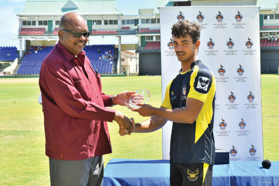 Tagenarine Chanderpaul accepts a commemorative plaque on behalf of his father Shivnarine Chanderpaul from Governor General of St. Kitts and Nevis, Sir S. W. Tapley Seaton.
