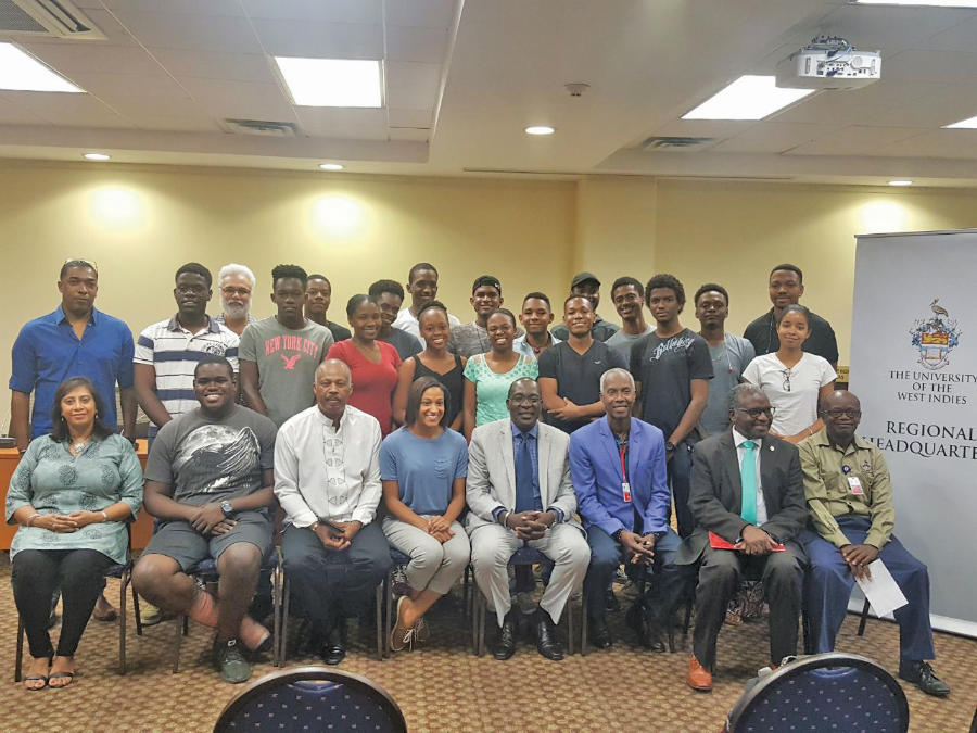 Vice-Chancellor Professor Sir Hilary Beckles (3rd left, seated) and Minister of Education, Senator the Hon. Ruel Reid (4th right, seated) and other officials of The UWI at a meeting with Software Engineering Students at the Mona campus students. The purpose of the meeting was to discuss the terms and conditions of the students' departure for Suzhou, China later this year as part of the BSc Software Engineering programme.